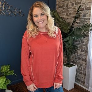Burnt orange reversed stitching long sleeve top.. Sizes small, medium, 2X, 3x